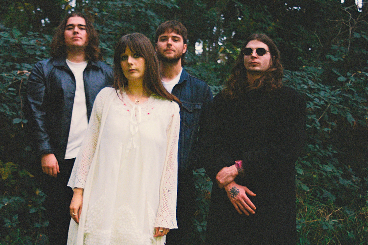 Adelaide band Oblivia Jean members posing together in a forest for a press photo captured by Lizzie Love.
